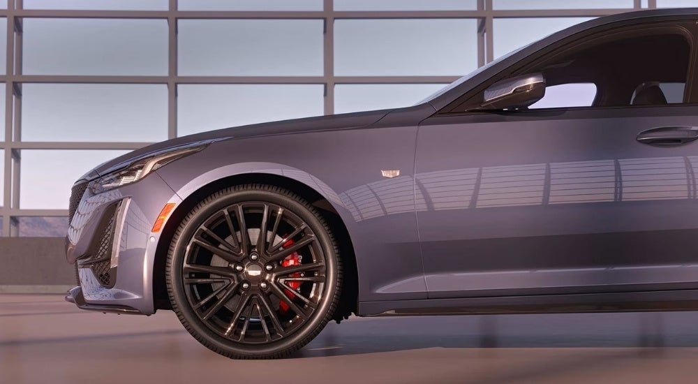 A close up shows a black wheel on a grey 2024 Cadillac CT5.