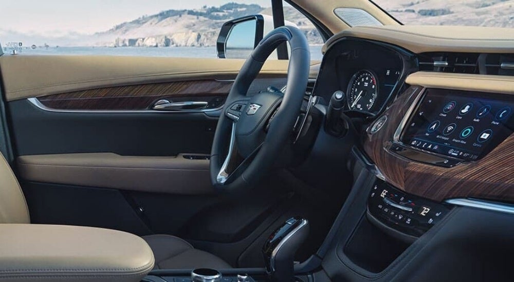 The black and tan interior is shown in a 2024 Cadillac XT6.