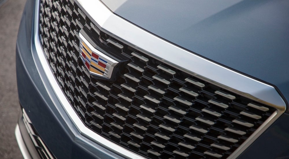 A close up shows the grille on a blue 2020 Cadillac XT5.