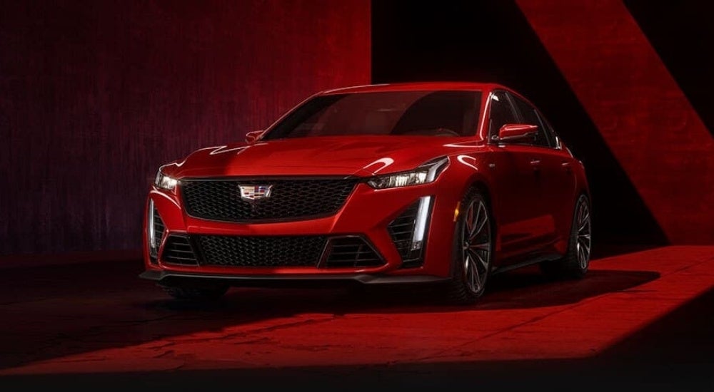 A red 2024 Cadillac CT5-V Blackwing is shown in a warehouse.
