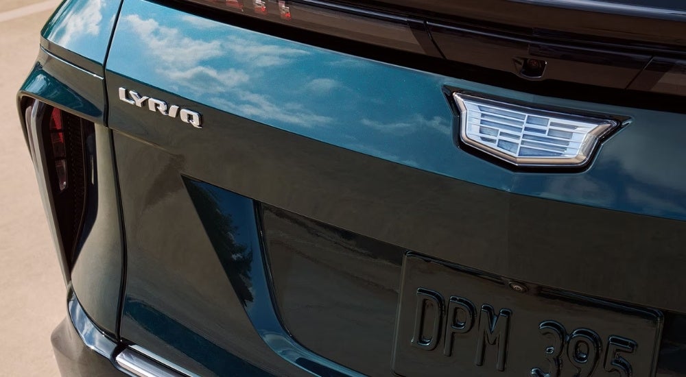 A close up shows the rear badging on a blue/green 2025 Cadillac LYRIQ.