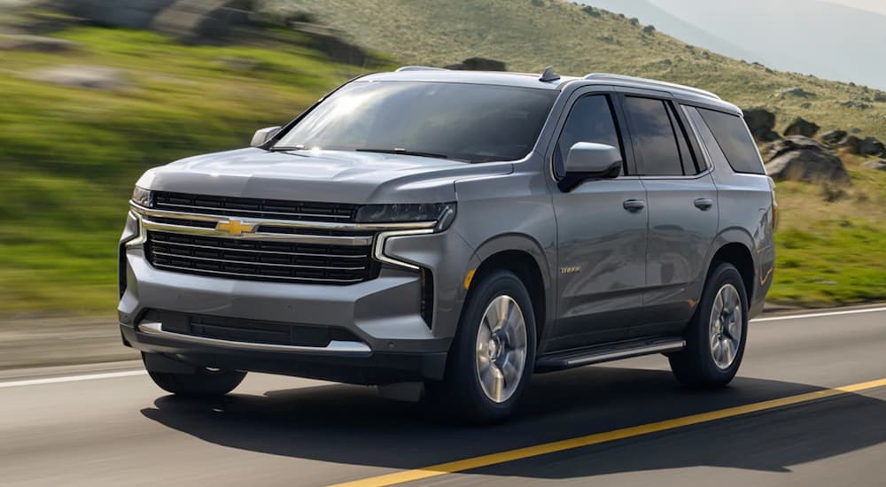 Grey 2021 Chevy Tahoe driving on a paved road.