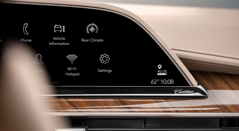 A close-up shows the infotainment screen in a 2023 Cadillac Escalade.