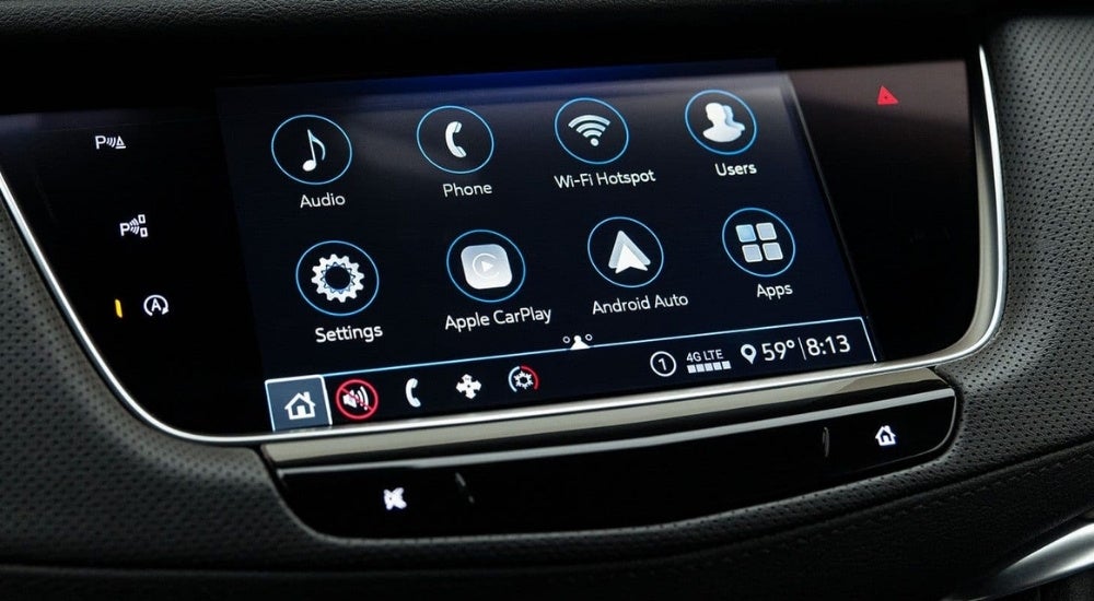 A close-up shows the infotainment screen in a 2023 Cadillac XT5.