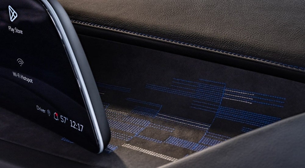 A close-up shows stitching on the black dash in a 2024 Cadillac XT4.