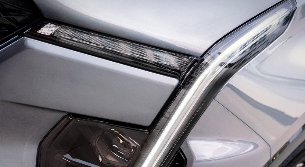 A close up shows headlight details on a white 2024 Cadillac XT4.