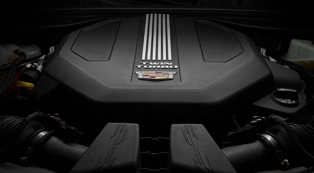 A close-up shows the engine in a 2024 Cadillac CT5.