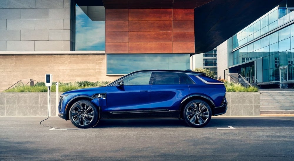 A blue 2024 Cadillac LYRIQ is shown charging.