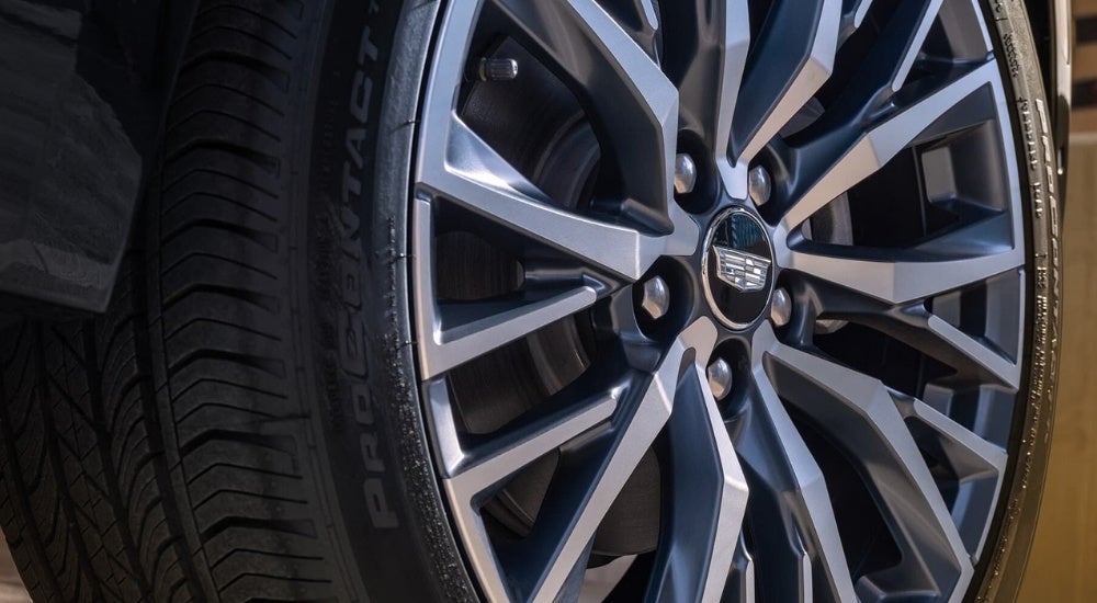 A close up shows a silver wheel on a grey 2024 Cadillac XT4.