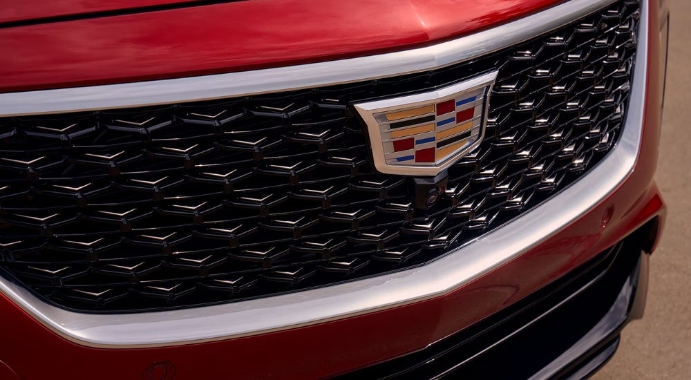 A close up shows the grille on a red 2025 Cadillac CT5.