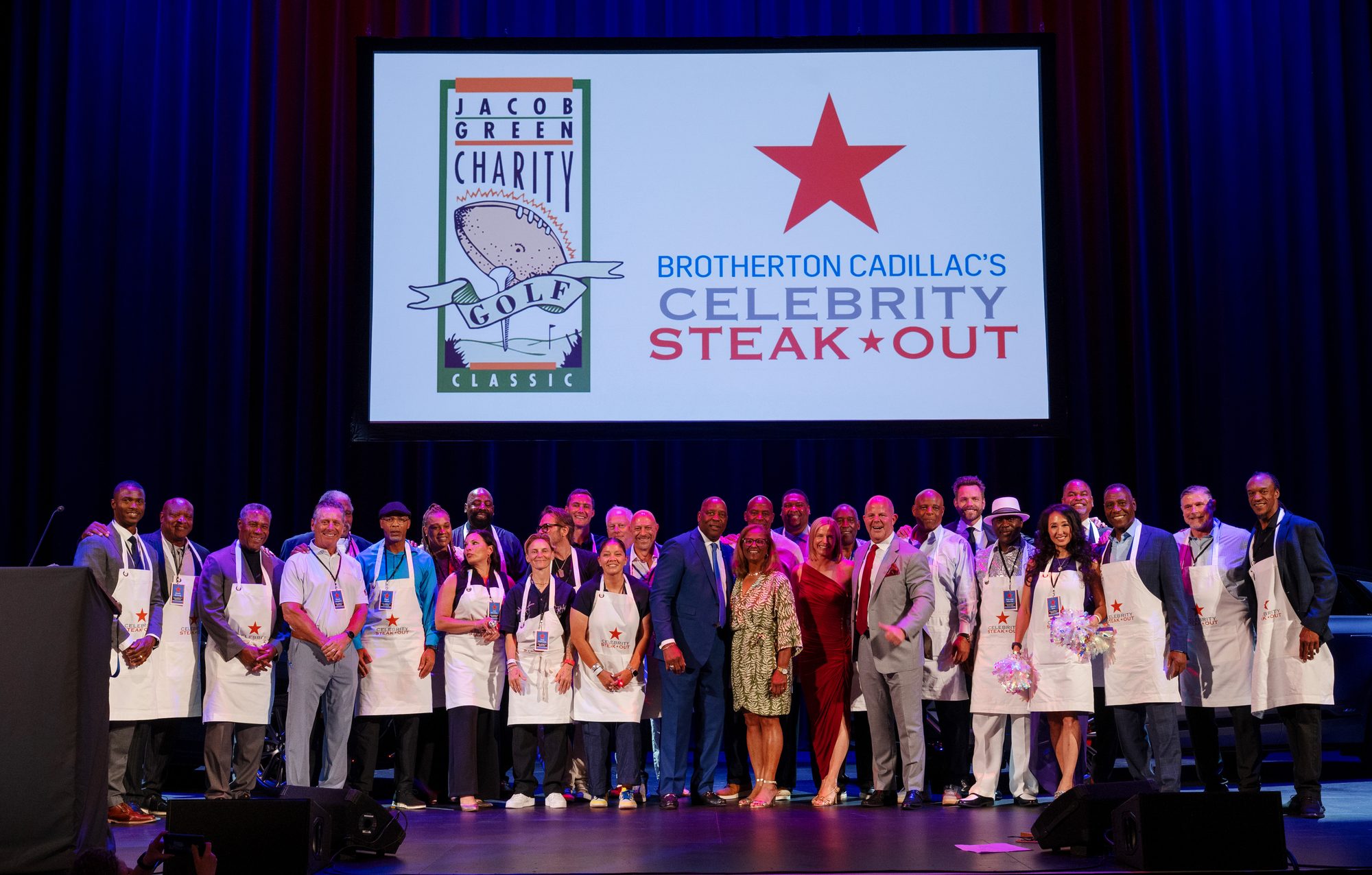 Celebrity servers on stage at Brotherton Cadillac's Celebrity Steak-Out with the Jacob Green Charity Golf Classic, benefiting Fred Hutch