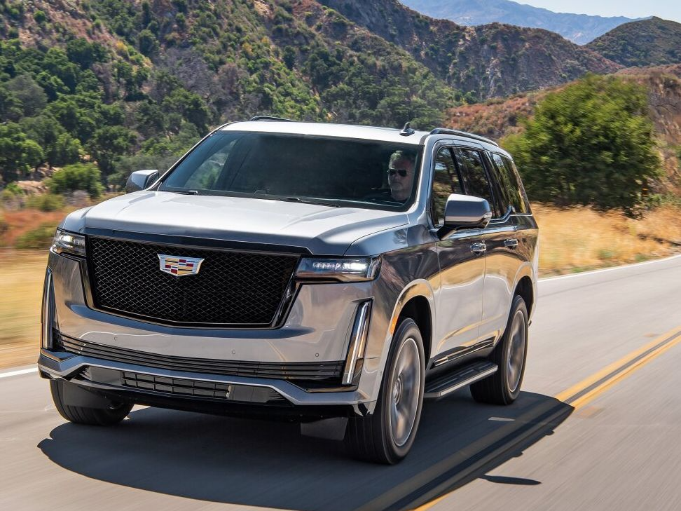 A Cadillac Escalade cruising along a road highlighting its luxury and style in Norwood, MA