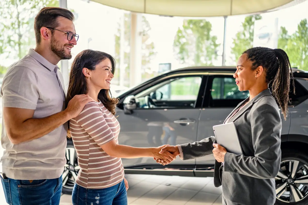 Couple trading in their car for a Cadillac at Cadillac of Norwood