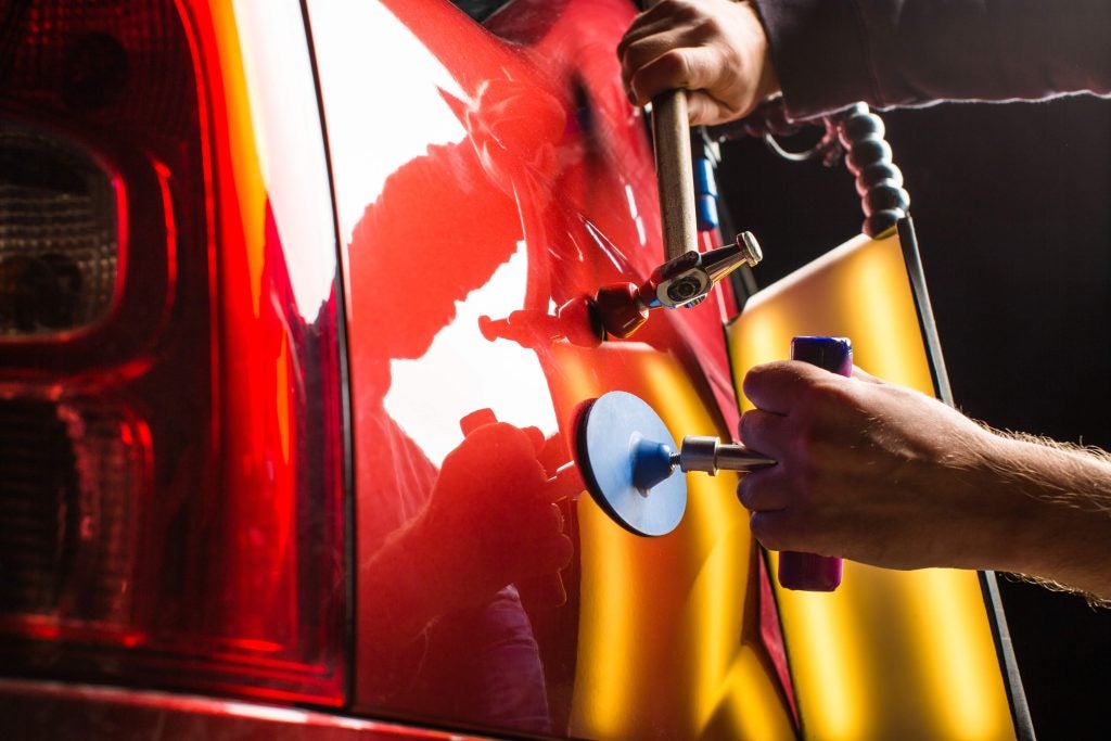Fixing a dent in a car