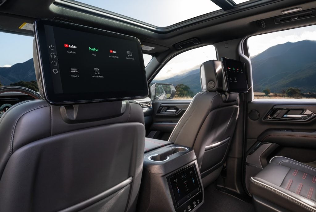 2026 GMC Yukon AT4 Ultimate rear view looking in at drivers back with gray interior and screens on both driver and passenger seat