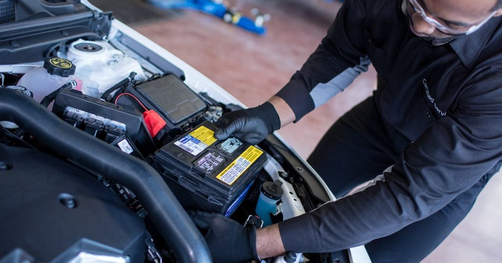 service technician installing vehicle battery