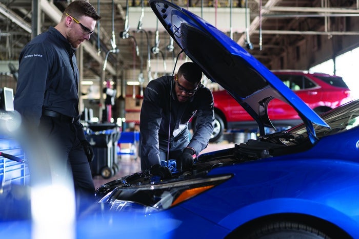 service technicians inspecting vehicle