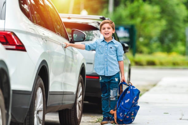 back-to-school image - child with backpack getting into SUV