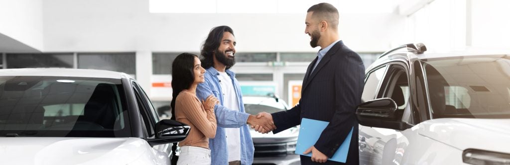customer consulting with dealership employee
