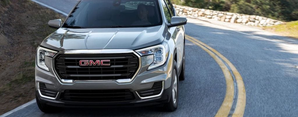 A grey 2022 GMC Terrain SLT is on a test drive at a used car dealer near Corpus Christi.