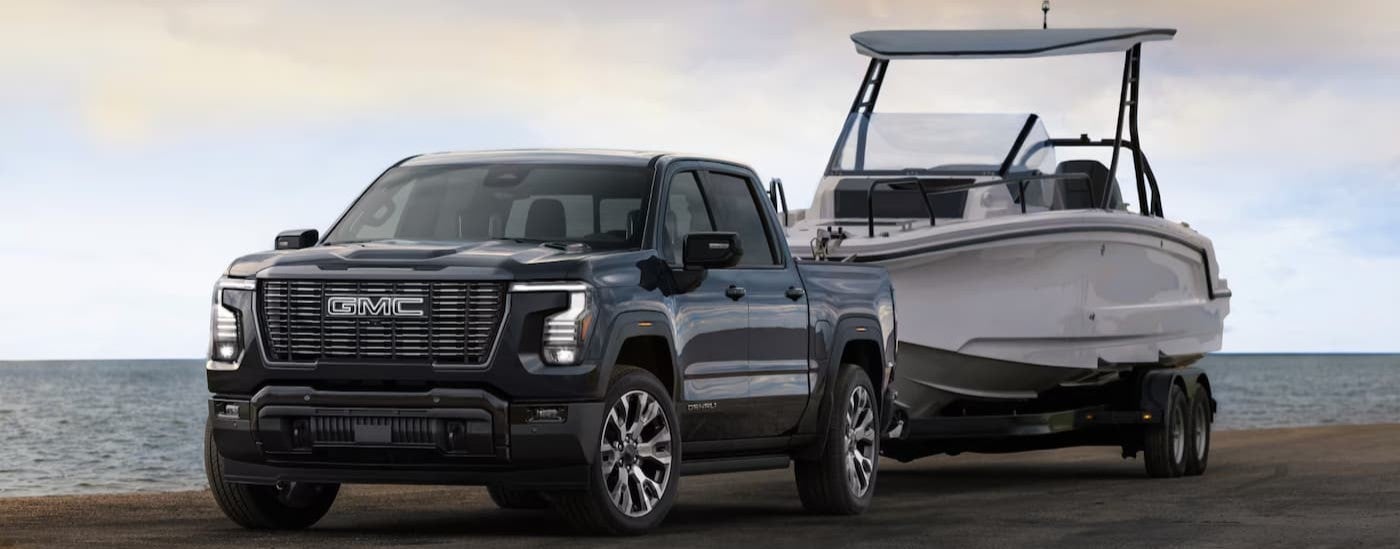 A gray 2027 GMC Sierra 1500 towing a boat.
