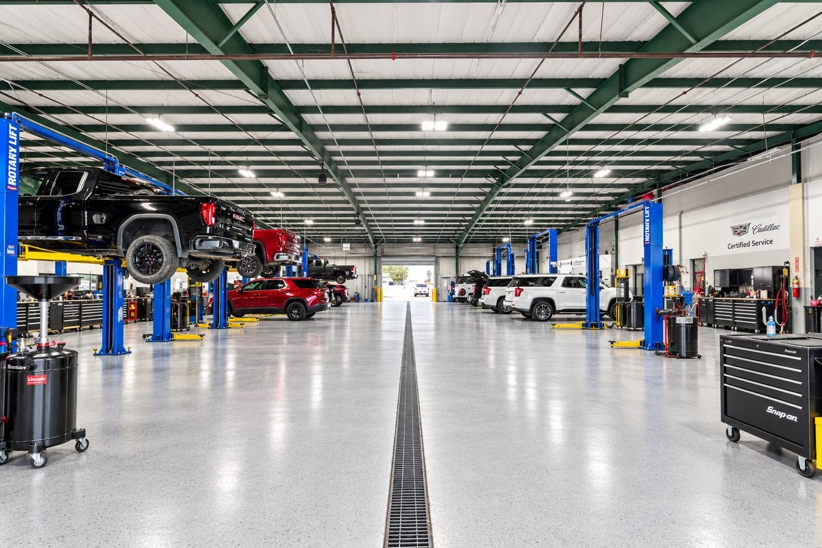 Service shop floor with vehicle lifts at Ross Downing GMC in Hammond, LA