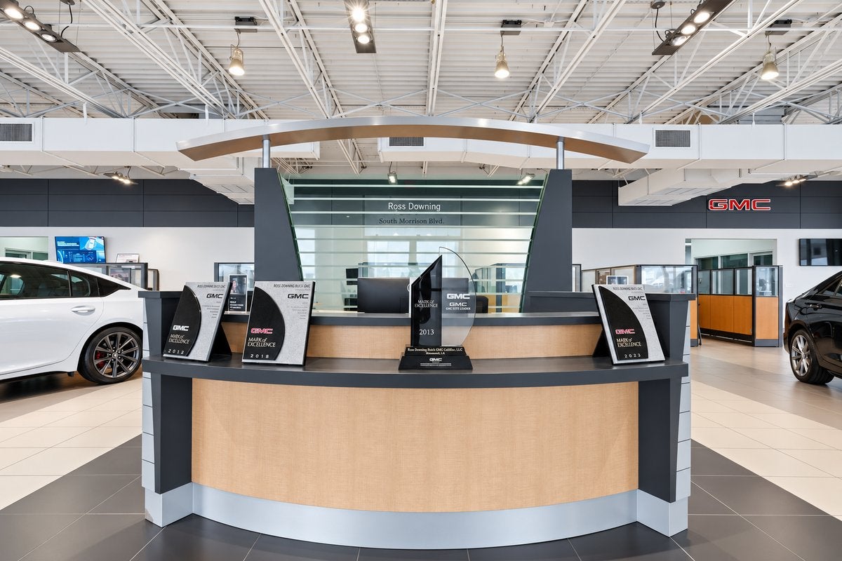 Showroom reception desk at Ross Downing GMC in Hammond, LA under the GMC sign