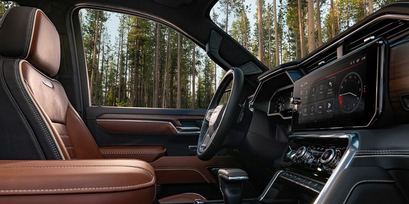 2026 GMC Sierra 1500 Denali cabin with brown leather seats and large digital displays, at Ross Downing GMC in Hammond, LA