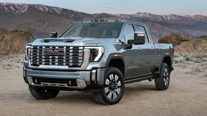 Silver 2026 GMC Sierra 2500 HD Denali parked on a desert road; GMC Sierra 2500 HD deals at Ross Downing GMC in Hammond, LA