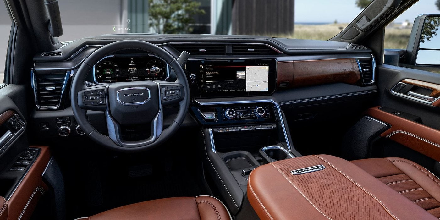 2026 GMC Sierra 2500 HD Denali Ultimate dashboard with digital displays and brown leather seats, at Ross Downing GMC in Hammond, LA