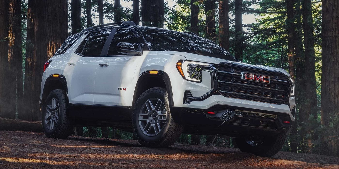 White 2027 GMC Terrain AT4 parked on a forest trail among tall trees, at Ross Downing GMC in Hammond, LA