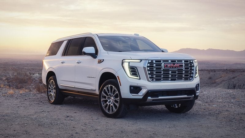 White 2026 GMC Yukon Denali parked on a desert overlook at sunset; GMC Yukon deals at Ross Downing GMC in Hammond, LA