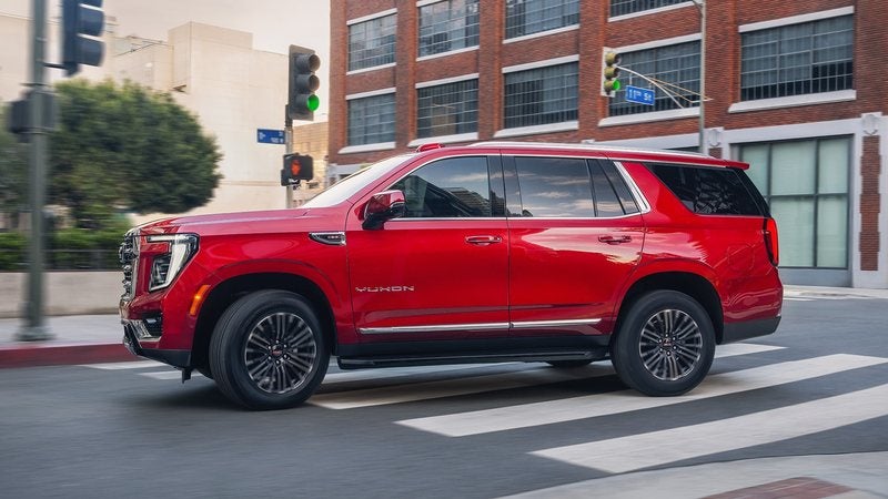 Red 2026 GMC Yukon Elevation on a city street; GMC Yukon financing at Ross Downing GMC in Hammond, LA