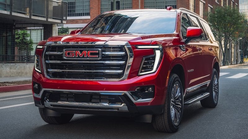 Red 2026 GMC Yukon Elevation on a city street; GMC Yukon XL financing at Ross Downing GMC in Hammond, LA
