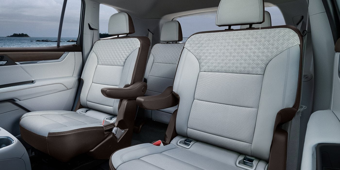 Light leather second-row captain's chairs and third-row seats in a 2027 GMC Acadia Denali, at Ross Downing GMC in Gonzales, LA