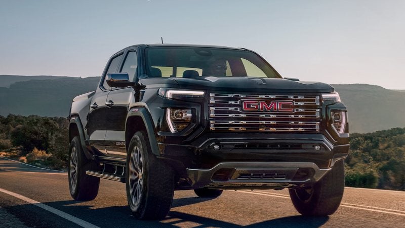 Black 2026 GMC Canyon Denali on a desert highway at dusk; GMC Canyon deals at Ross Downing GMC in Gonzales, LA