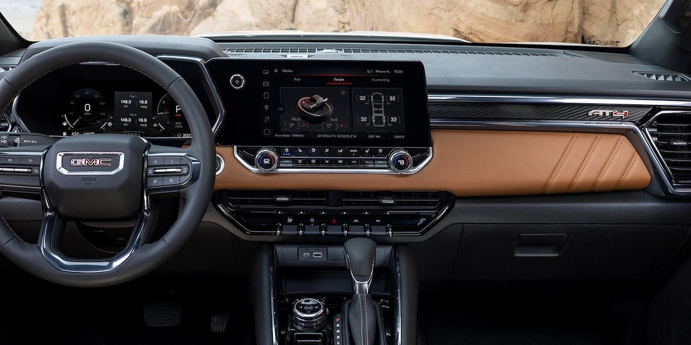 2026 GMC Canyon AT4 dashboard with an 11.3-inch touchscreen and tan accents, at Ross Downing GMC in Gonzales, LA