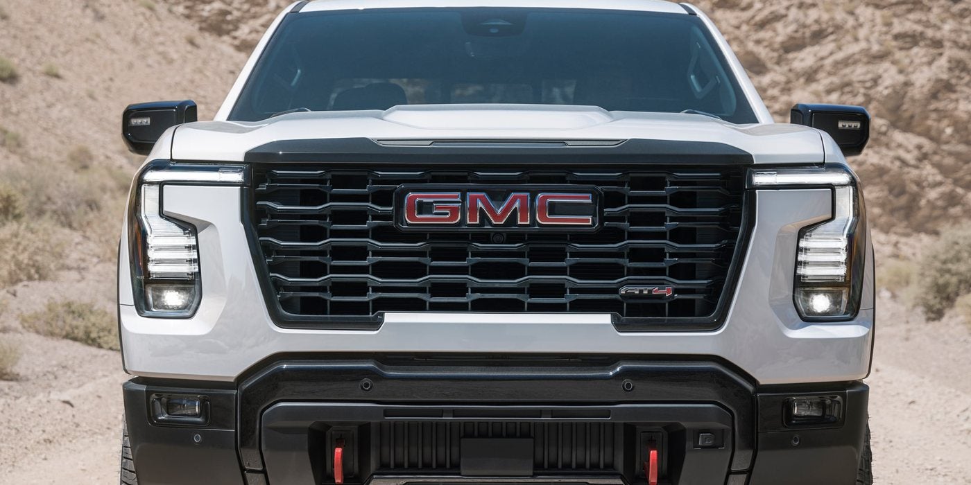 Front of a white 2027 GMC Sierra 1500 AT4 with red recovery hooks; 2027 Sierra AT4 vs Denali at Ross Downing GMC in Gonzales, LA