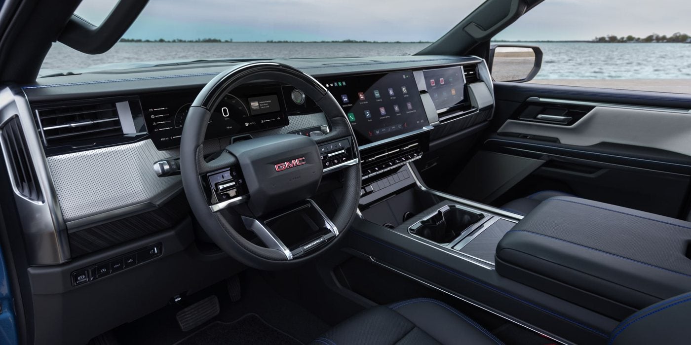2027 GMC Sierra 1500 Denali cabin with a wide digital dash and touchscreen; GMC Sierra interior at Ross Downing GMC in Gonzales, LA