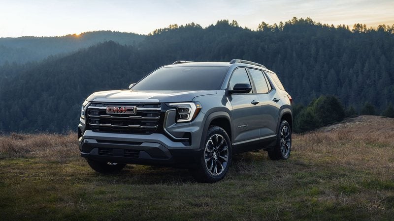 Gray 2027 GMC Terrain Elevation parked on a grassy hillside at dusk; GMC Terrain deals at Ross Downing GMC in Gonzales, LA