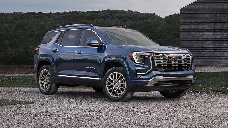 Blue 2027 GMC Terrain Denali parked on gravel beside a barn; trade in your vehicle at Ross Downing GMC in Gonzales, LA
