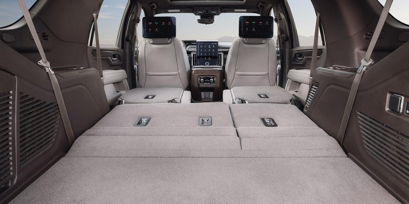 Cargo area of a 2027 GMC Yukon with the second and third rows folded flat, at Ross Downing GMC in Gonzales, LA