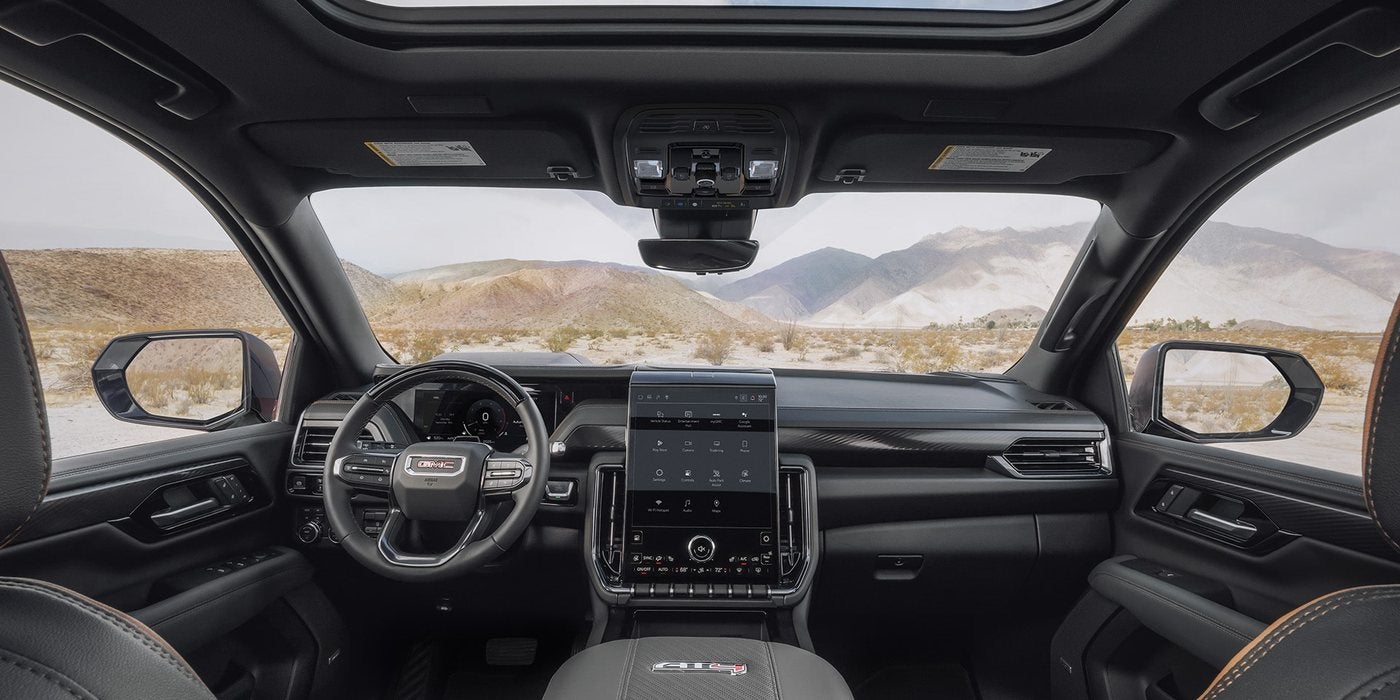 2027 GMC Yukon dashboard with a 16.8-inch touchscreen under a panoramic sunroof, at Ross Downing GMC in Gonzales, LA