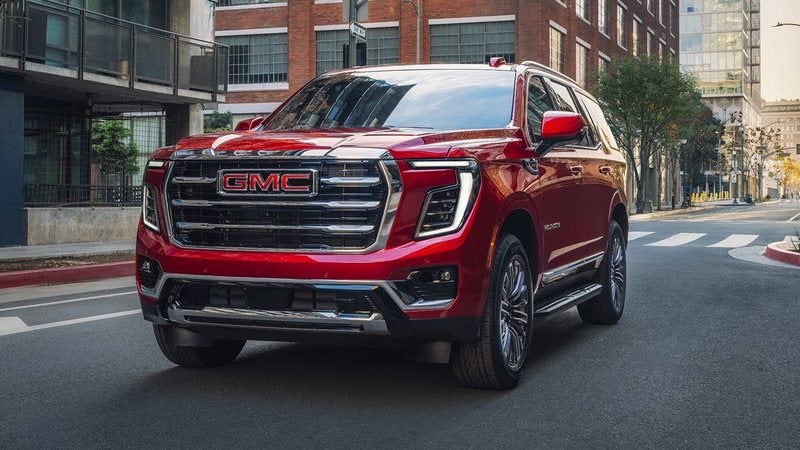 Red 2027 GMC Yukon Elevation on a city street; GMC Yukon deals at Ross Downing GMC in Gonzales, LA