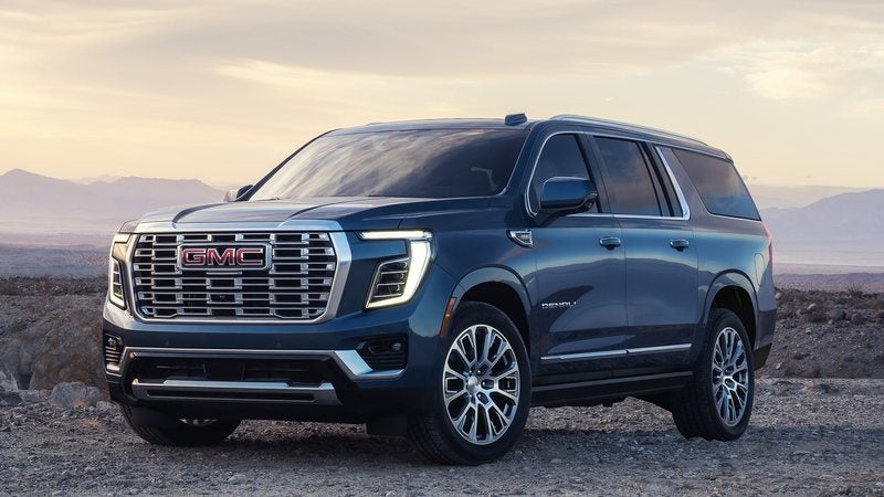 Blue 2027 GMC Yukon XL Denali on a desert overlook; GMC Yukon XL deals at Ross Downing GMC in Gonzales, LA