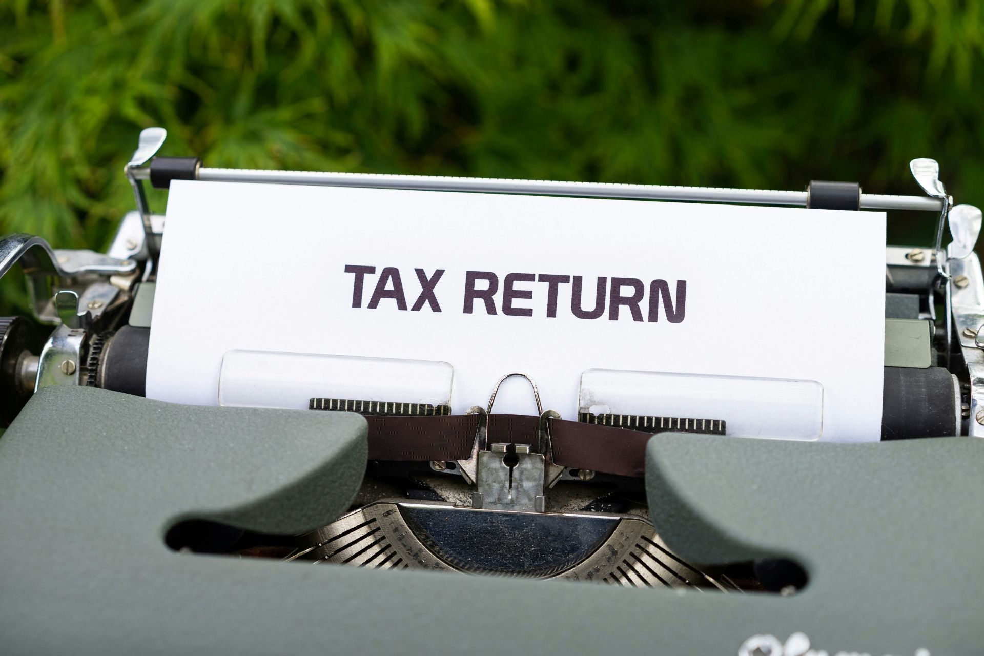 Typewriter with paper that says "TAX RETURN"