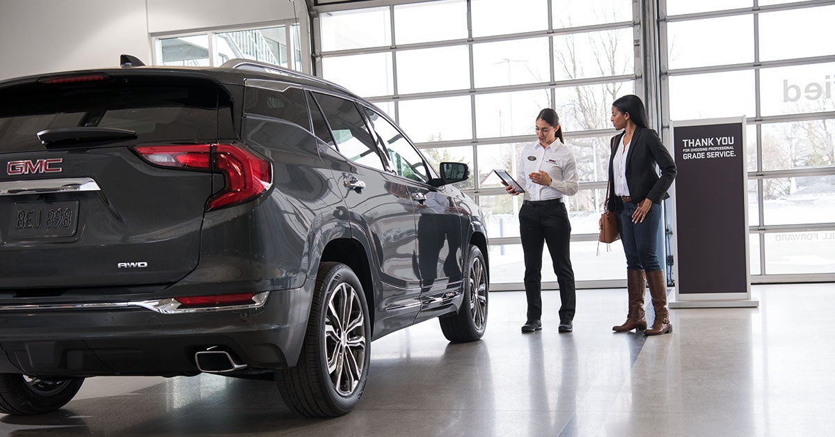 Customer working with GMC staff on trading in an SUV