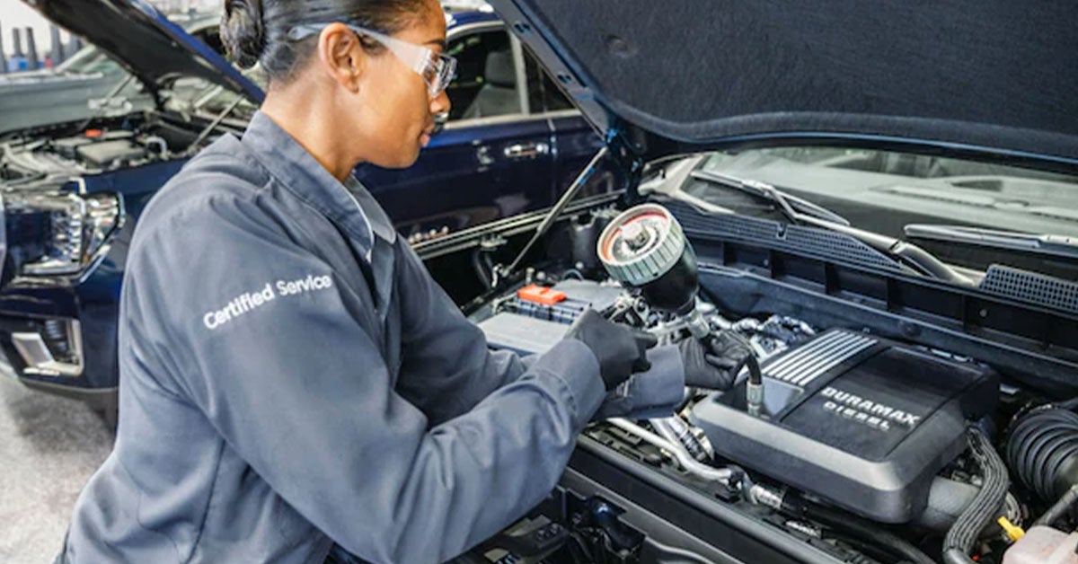 GMC service technician conducting an oil change.