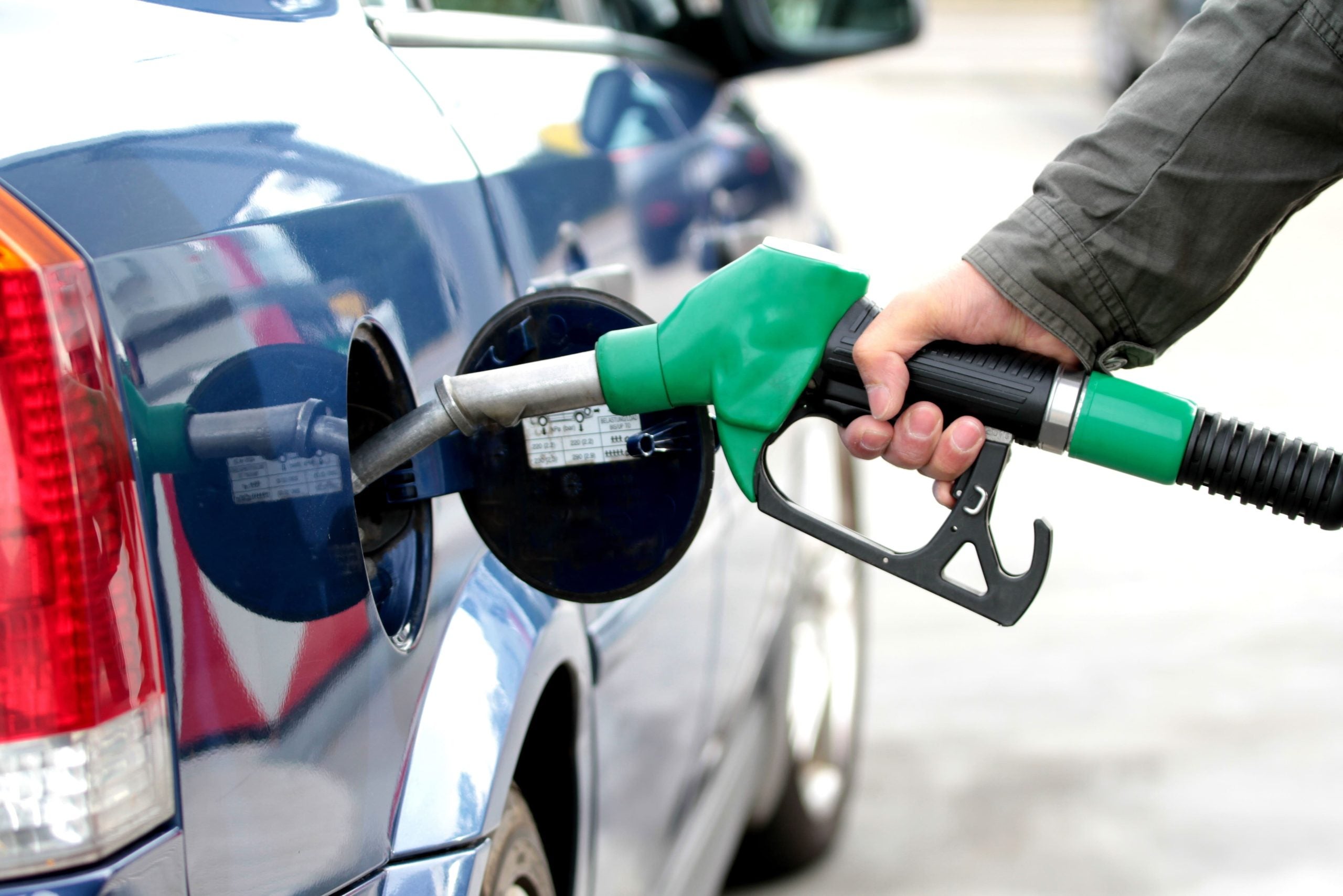 Person putting gas in a GMC car