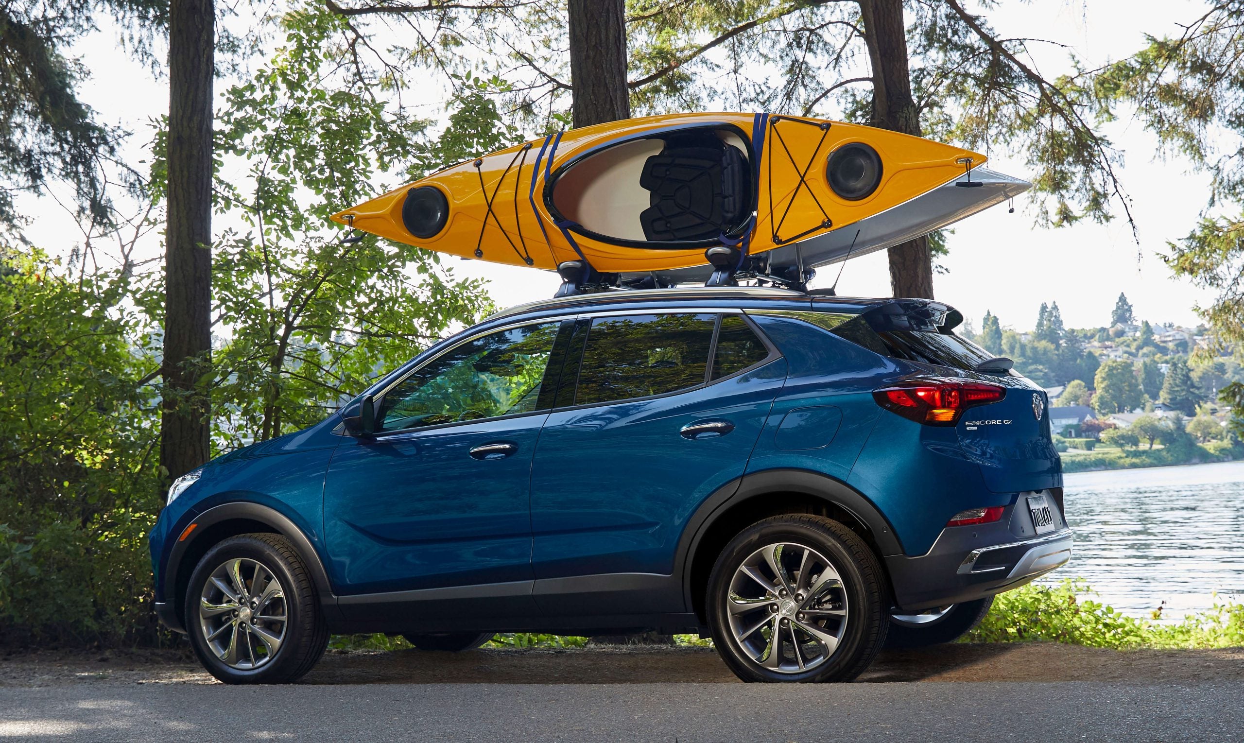 A used 2020 Buick Encore has a kayak on its roof.
